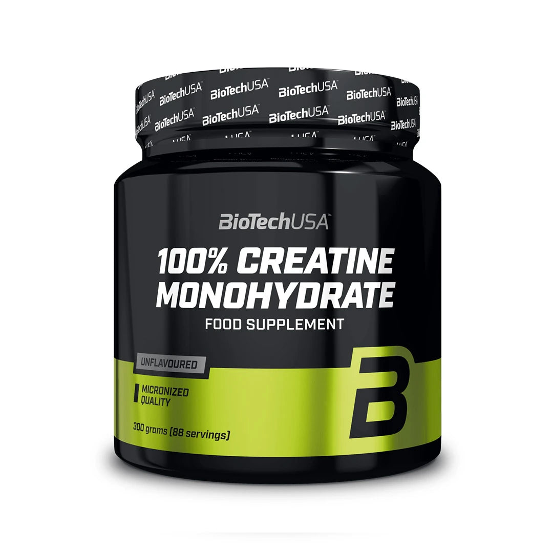BioTechUSA 100% Creatine Monohydrate 300 g on maustamaton kreatiinijauhe mustassa purkissa, jossa on vihreitä yksityiskohtia., kuva 1/1