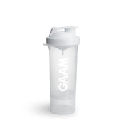 GAAM Smartshake Slim 500 ml -shakeri läpinäkyvää muovia, jossa on valkoinen kansi, valkoinen logo ja lisälokero pohjassa.