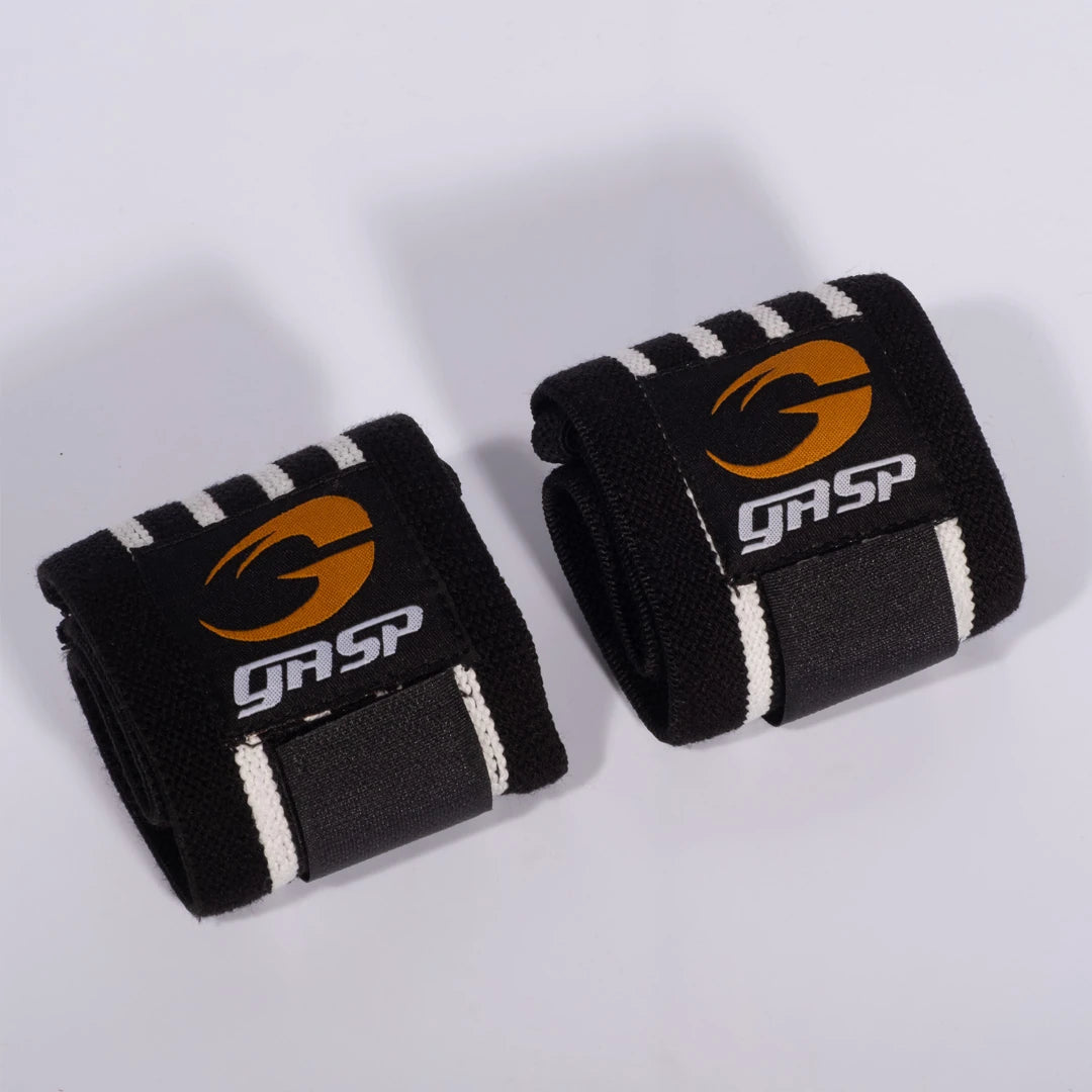 Vahvat mustat GASP Hardcore Wrist Wraps Black/White -rannesiteet joustavaa kangasta valko-oranssilla logolla., kuva 1/1