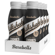 8 x Barebells Milkshake 330 ml Cookies & Cream valkoisessa laatikossa, jossa on mustia pulloja valkoisin yksityiskohdin.