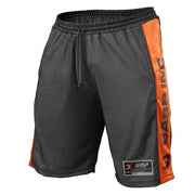 Gasp No1 Mesh Shorts Black & Flame -treenishortsit mustaa verkkomateriaalia oransseilla sivuraidoilla.