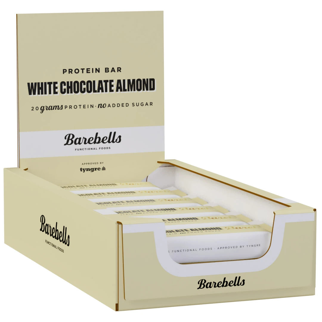 12 x Barebells Protein Bar 55 g White Chocolate Almond beigessä laatikossa valkoisilla ja mustilla yksityiskohdilla., kuva 1/1