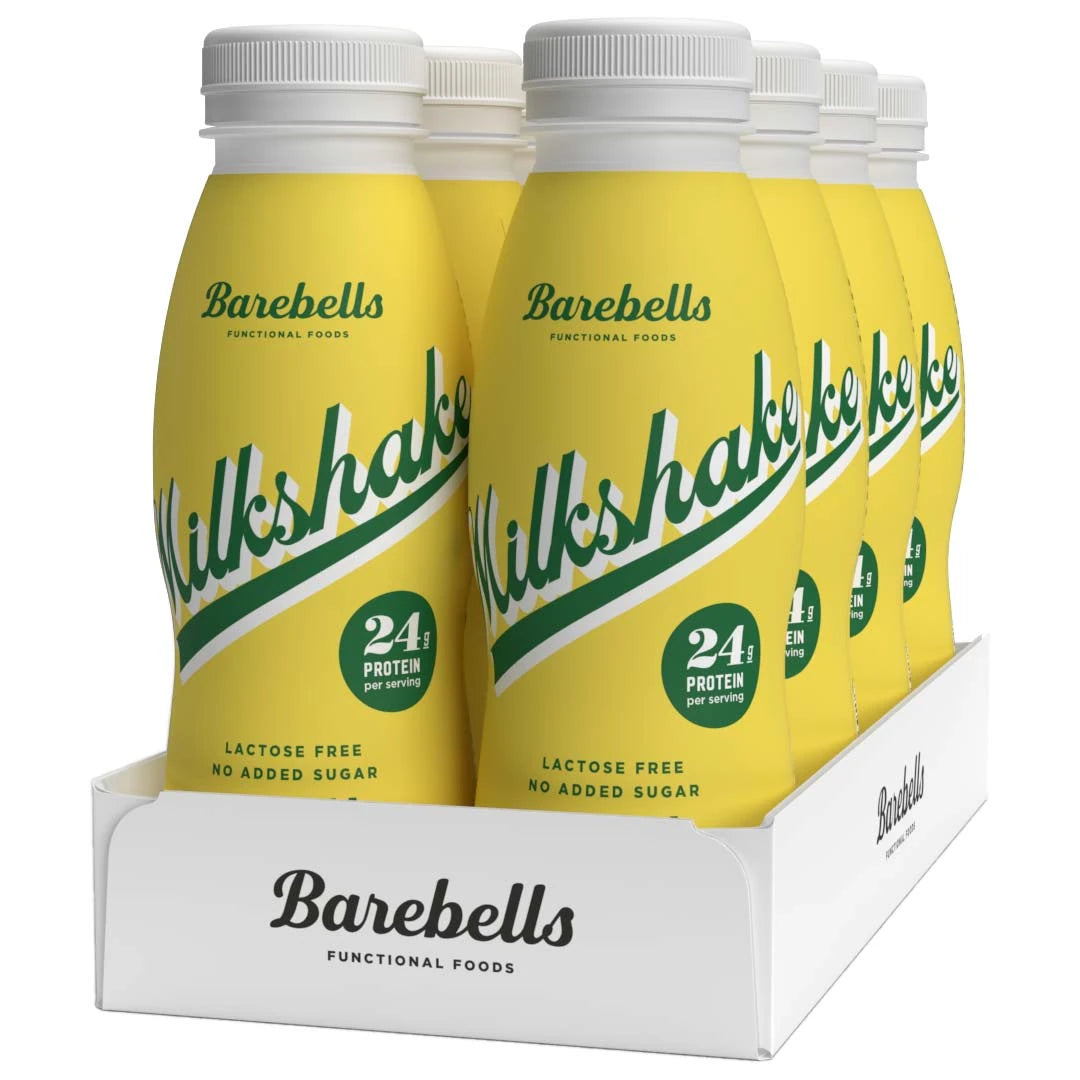 8 x Barebells Milkshake 330 ml Banana i gula flaskor med grön text samlade i ett vitt flak., bild 1 av 1